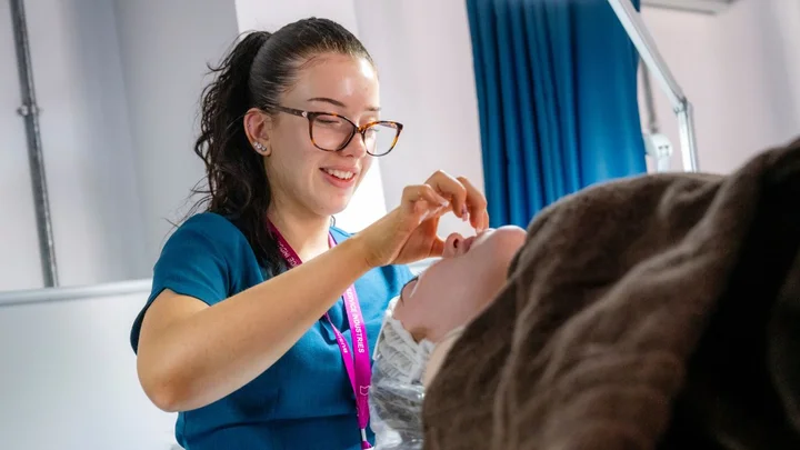 Beauty Therapy student performing a treatment on a client in a commercial salon training environment at The Manchester College.