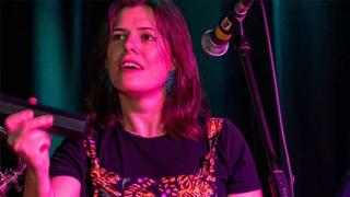 A close up shot of College music tutor Rosie Fortune performing on stage.