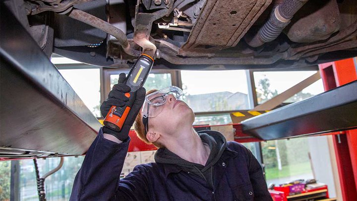 Mechanic looking underneath a car