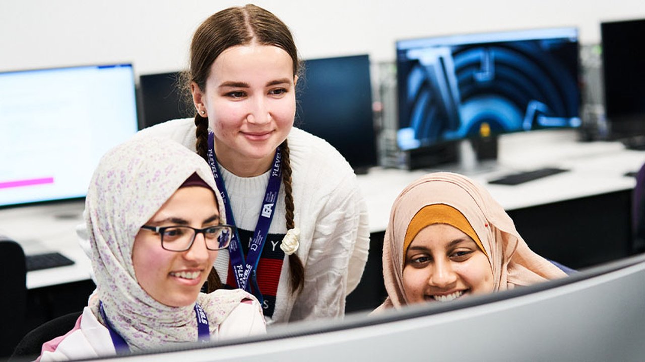 Photograph of three T Level students in a classroom setting.