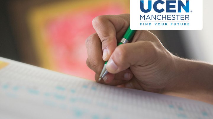 Close-up of someone writing in a table