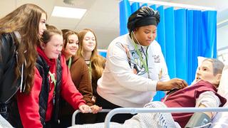 Students doing a practical nursing exercise