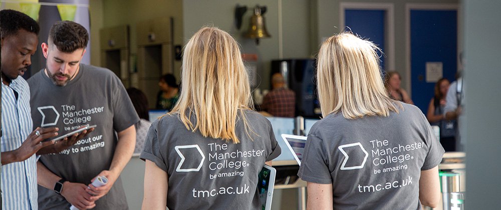 Manchester College staff welcoming guests to an open event