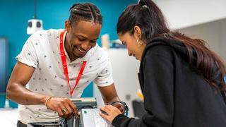 Two students doing practical work during their computing course.
