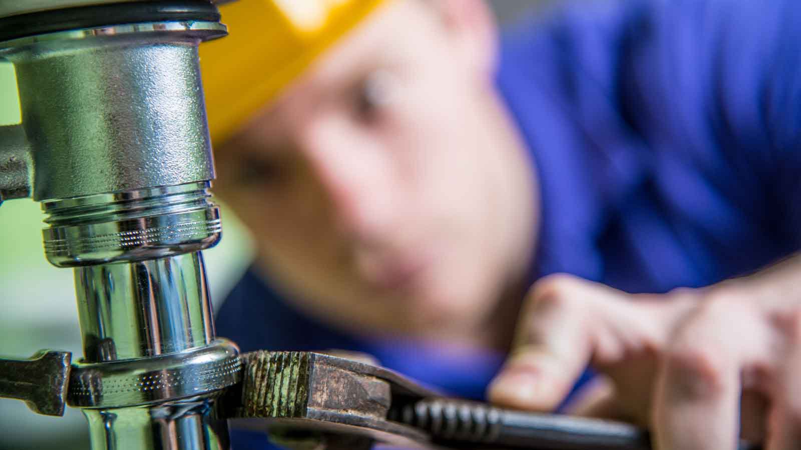Close-up of a plumber fixing pipework