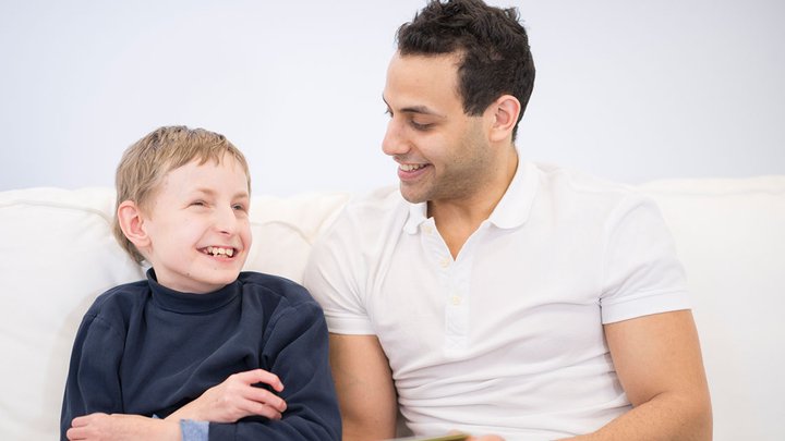 A man laughing with a child