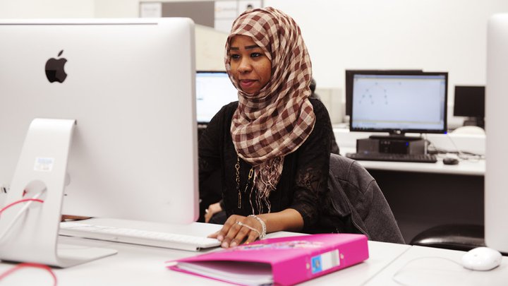 A lady sitting an exam on a computer