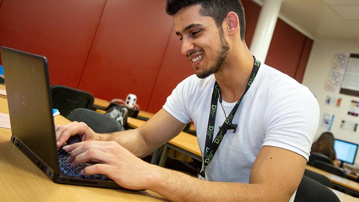 A stduent working on a laptop