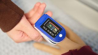 Close-up of a pulse oximeter placed on a person’s finger during a practical health care learning activity at The Manchester College.