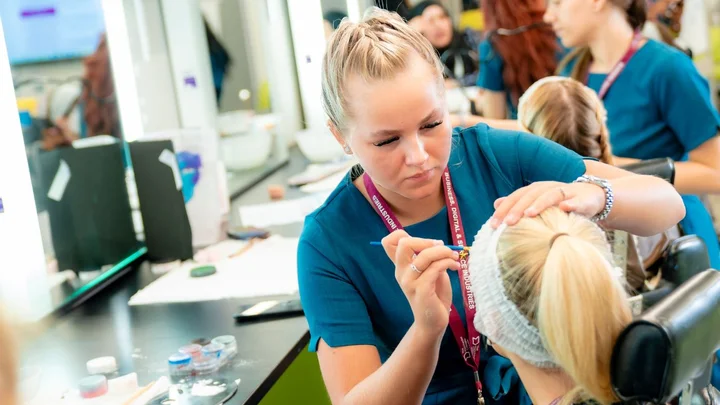 Beauty Therapy student applying make up to a client in The Manchester College's industry-standard salon facilities.