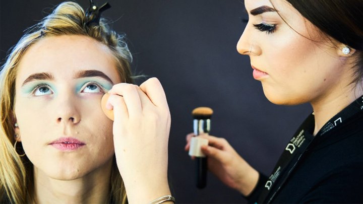 Manchester College student applying theatrical make-up