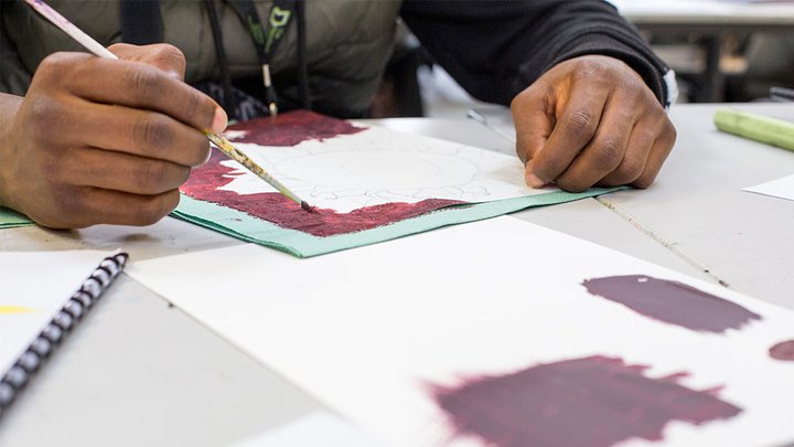 Close-up on an art student creating a piece of work