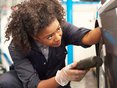 Female mechanic working on a car