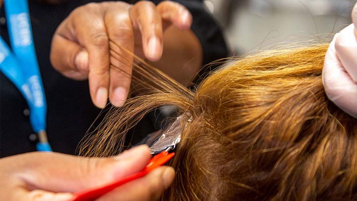 Close-up of hair being cut