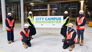 Staff and students from The Manchester College unveil the name 'City Campus Manchester'.