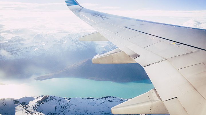 An aeroplane flying above a mountain range