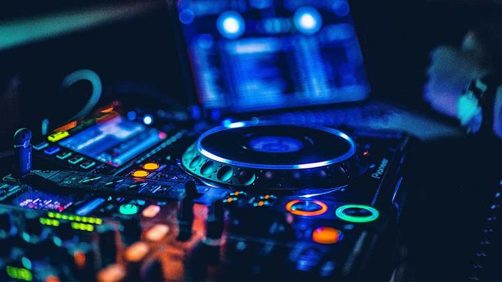 Close-up of a DJ turn-table lit up in the dark