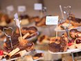 Selection of freshly made cakes with a Manchester College flag sticking out