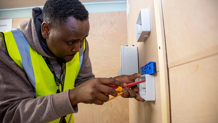 Student electrician wiring in a socket