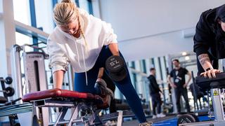 Student at The Manchester College using free weights in the gym at Openshaw.