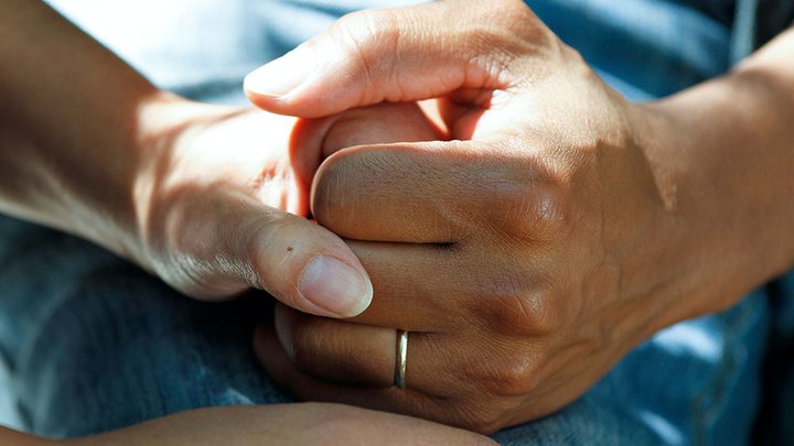 Two people holding hands