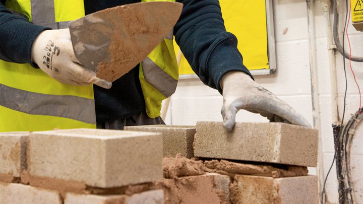 Student creating a brickwork wall