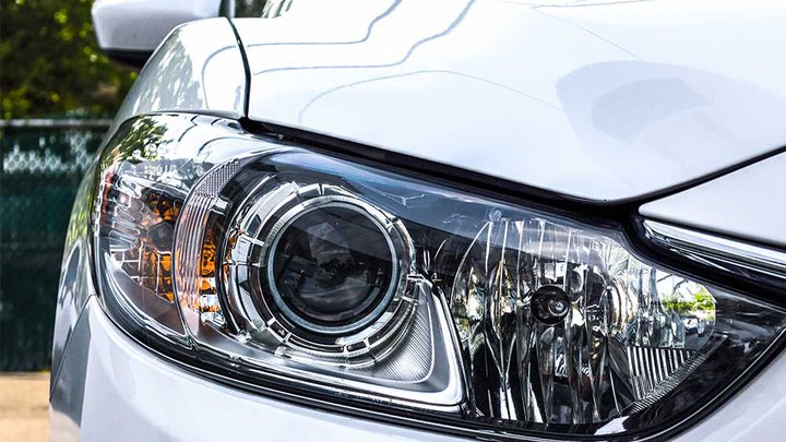 Close-up of a car headlamp and bodywork