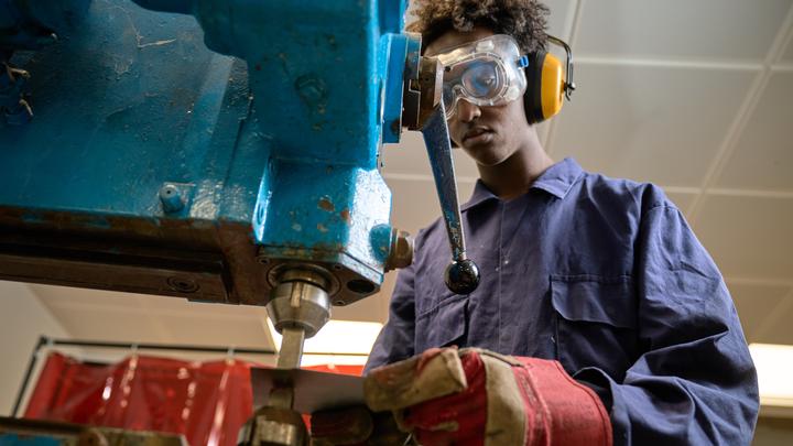 A student using machinery