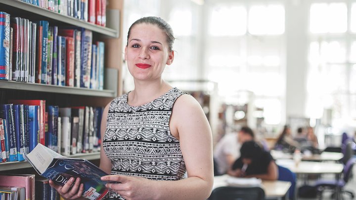 A teacher holding a dictionary