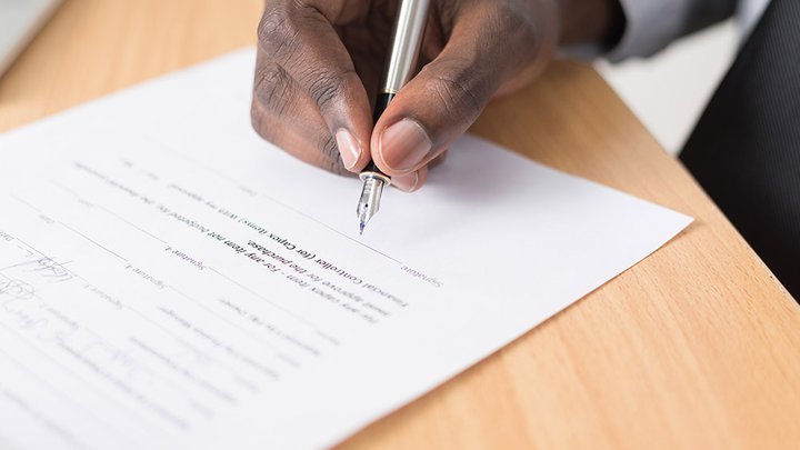 Close-up of someone signing a contract