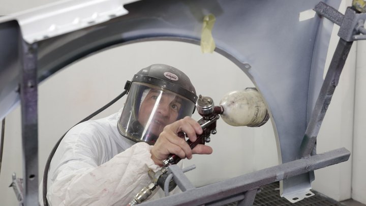 Accident repair mechanic working on a car