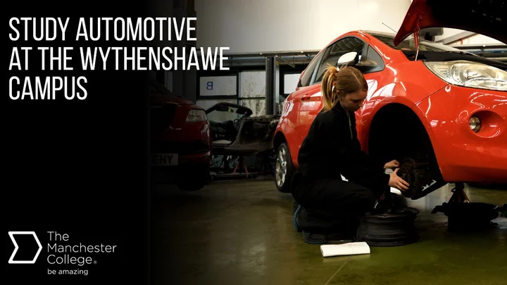 Student carrying out maintenance on a red car in an automotive workshop at The Manchester College Wythenshawe Campus during a hands-on motor vehicle course.