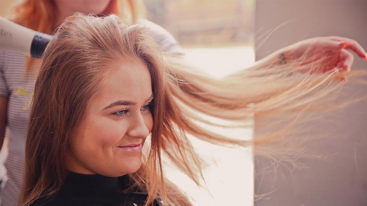 Woman having her hair blow dried