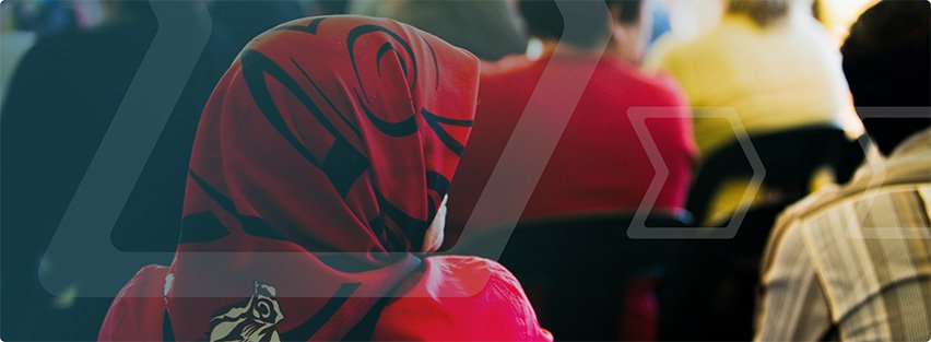 Woman wearing a head scarf sat in a classroom