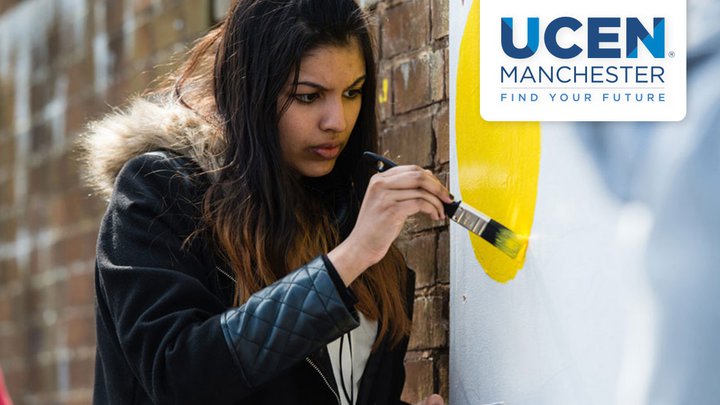 A student painting a communal wall