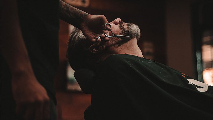 A customer having their beard trimmed