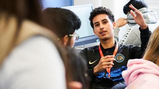 Student engaging with a tutor in a business class.