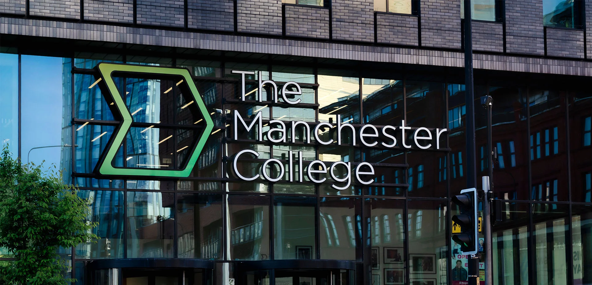 Exterior view of the City Campus Manchester, displaying The Manchester College logo