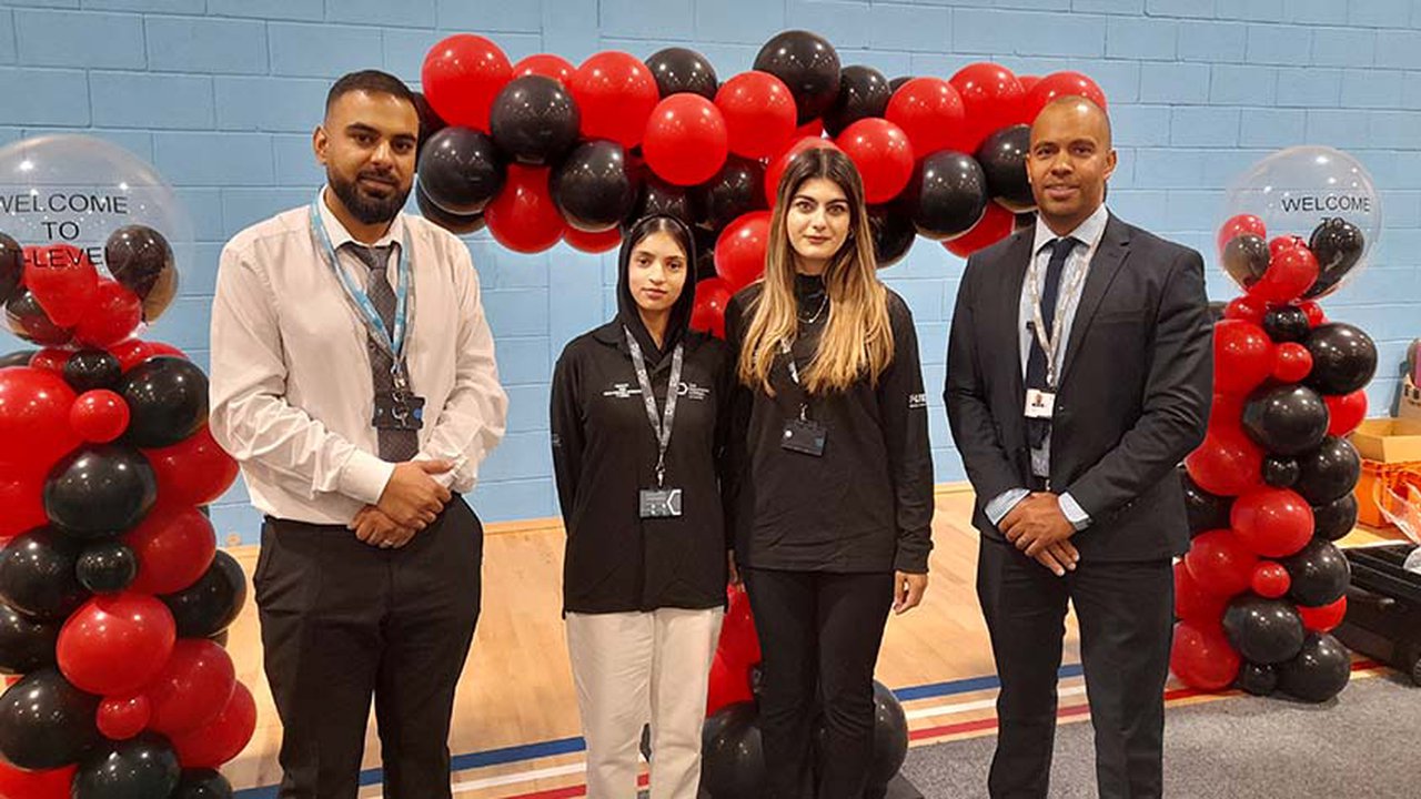 Photograph of The Manchester College students Kashaf Nadeem and Tara Jabar (centre) alongside Tutor Mohammad Raja (left) and Assistant Principal Julian Smith (right).