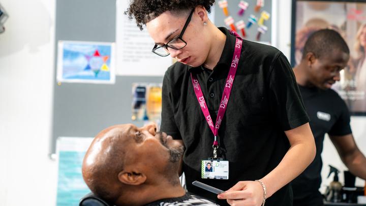 Barbering student with cilent