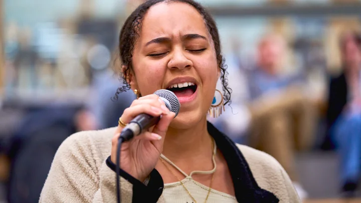 Student singing into a microphone