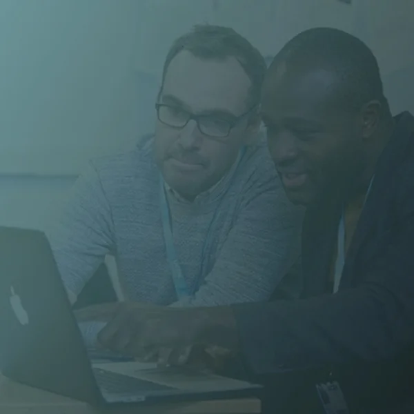 Two people working together on a laptop