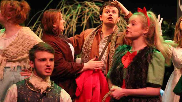 Female and male students in costume performing