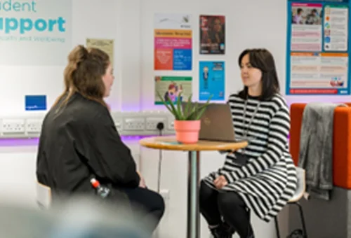 Two people sat at a table talking