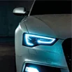Close-up of a front of a car with it's headlights on