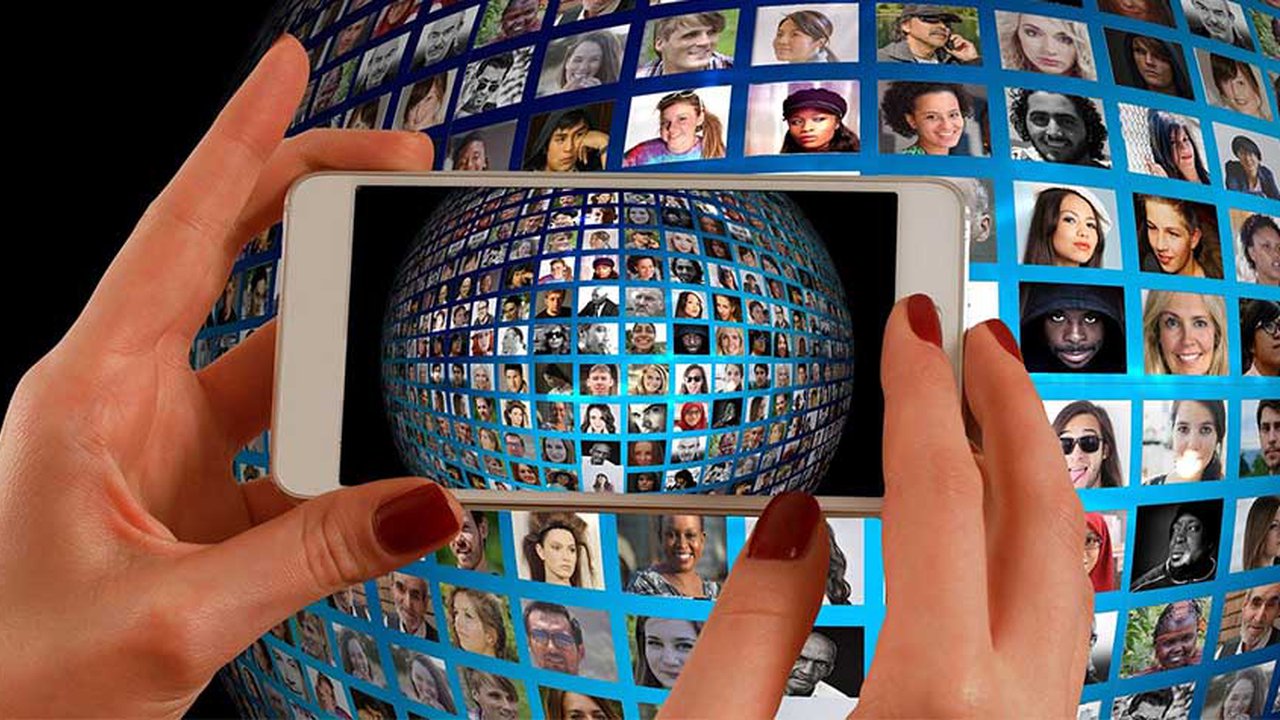 Hands holding a mobile phone with picture of a globe