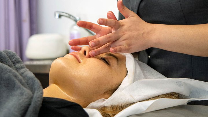 A customer having a facial massage