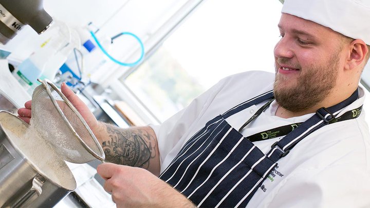 Catering student preparing food